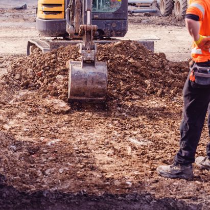 An excavator grading the land