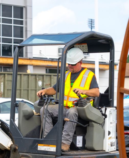 Worker operating an excavator